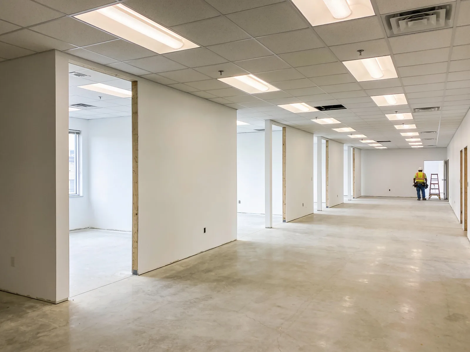 Lease-ready commercial suite with new demising walls, fresh paint, and a finished ceiling grid.